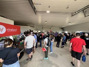Group of people at an event in an industrial setting.